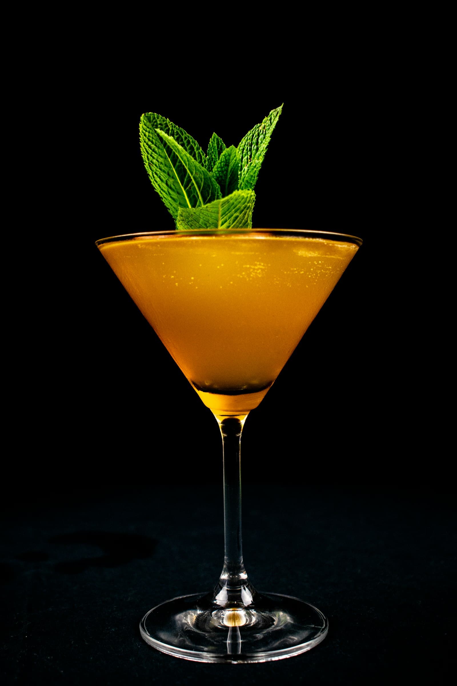 A row of summer cocktails on a Toronto backyard patio table